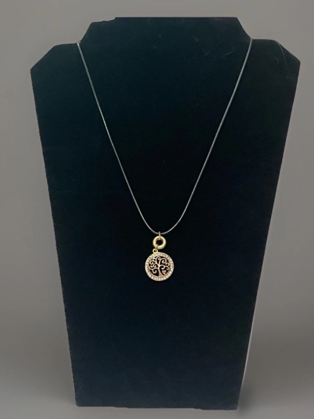 Wicca Gold and Silver round pendant necklace with a tree of life on leather.